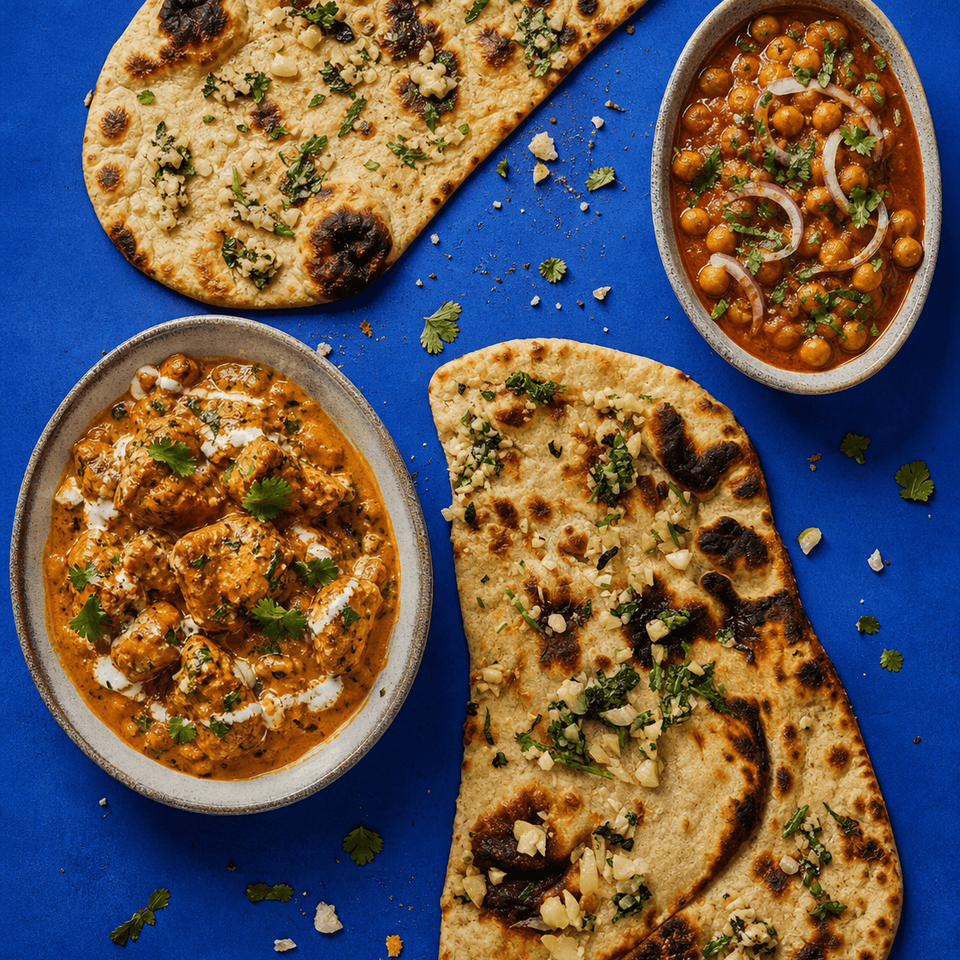 Fresh garlic naan bread from the tandoor with garlic and herbs.